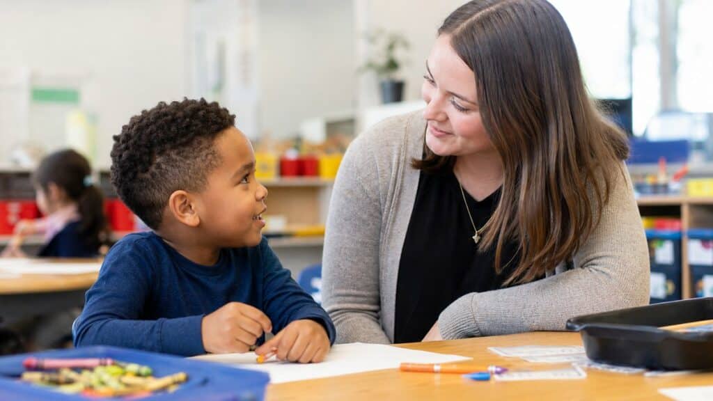 A teacher with a young child, illustrating what is a multilingual learner