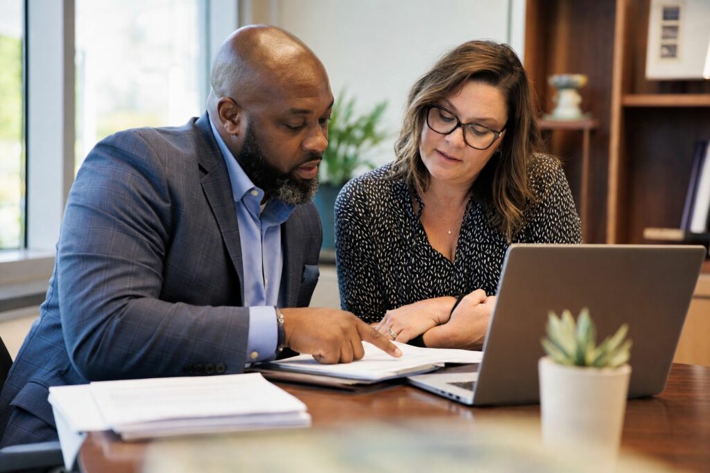 District administrator and purchasing officer reviewing a sole source justification for an EdTech purchase